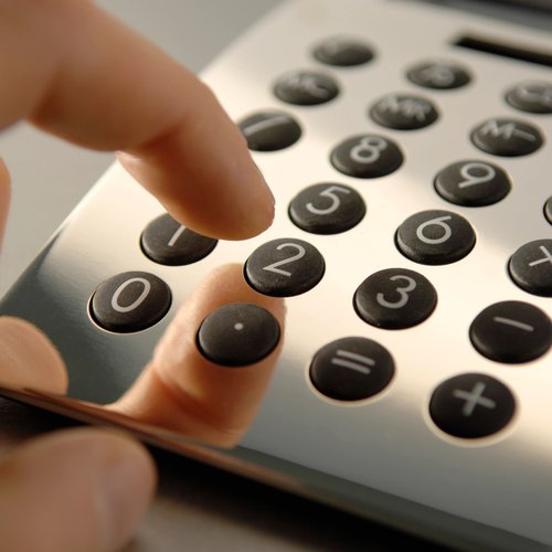 closeup of person using a calculator - Classic Carpets in Midland, TX