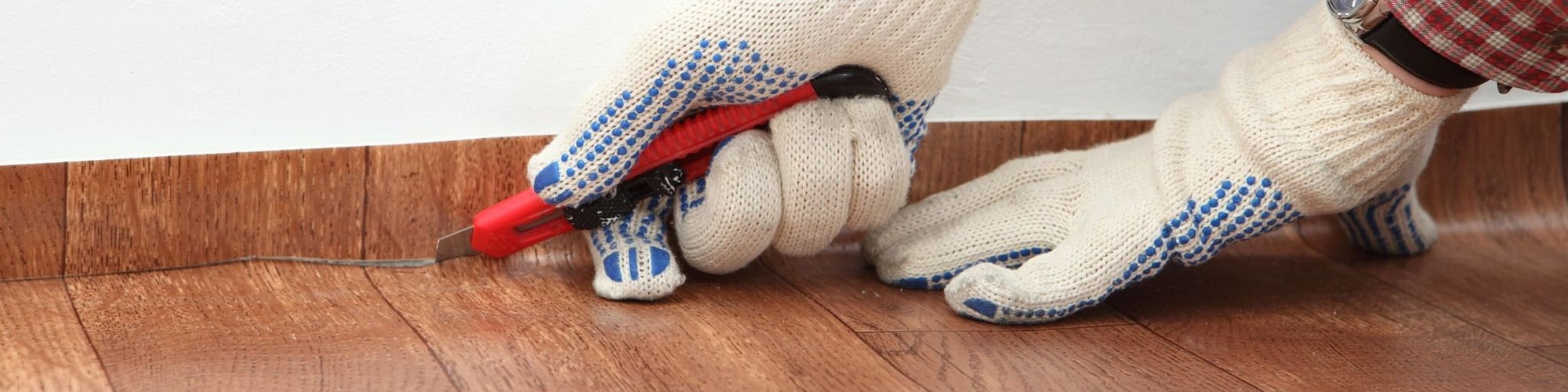 closeup of person installing vinyl flooring - Classic Carpets in Midland, TX