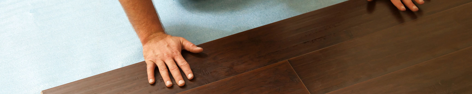 closeup of person installing flooring - Classic Carpets in Midland, TX